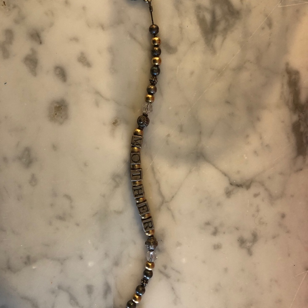 Darling silver and beaded bracelet spells Mother measures 7.5” long
